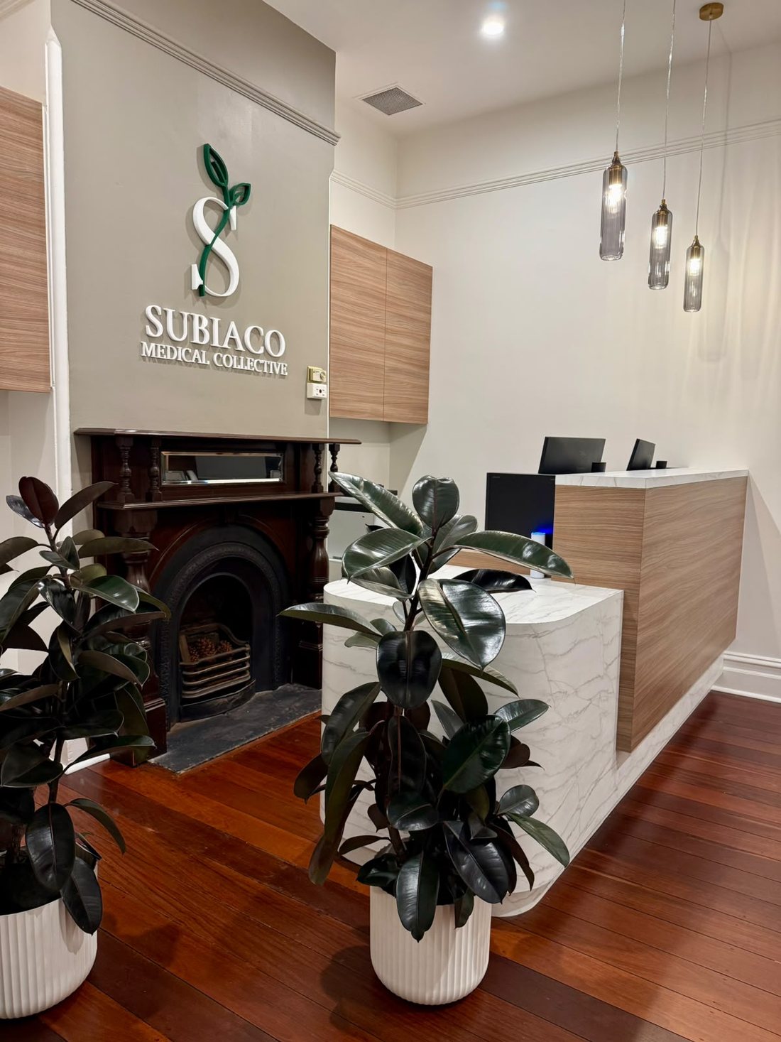 Reception at Subiaco Medical Collective, with the practice signage above the original fireplace
